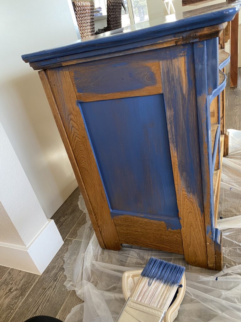 A picture of the painting process of a dresser being refinished with rust-oleum costal blue 